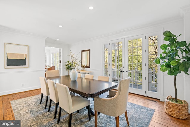 dining area featuring french doors, plenty of natural light, and hardwood / wood-style floors