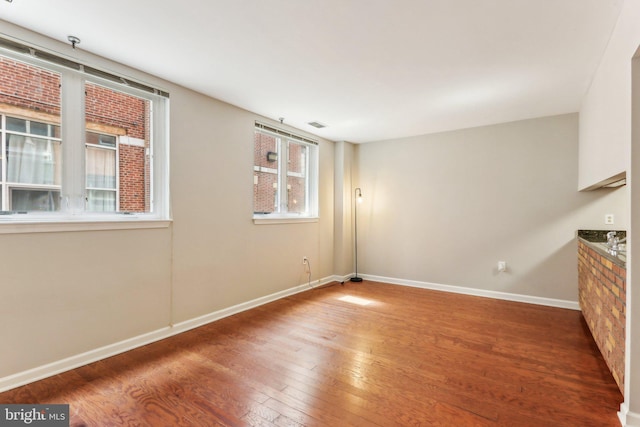 empty room with hardwood / wood-style floors