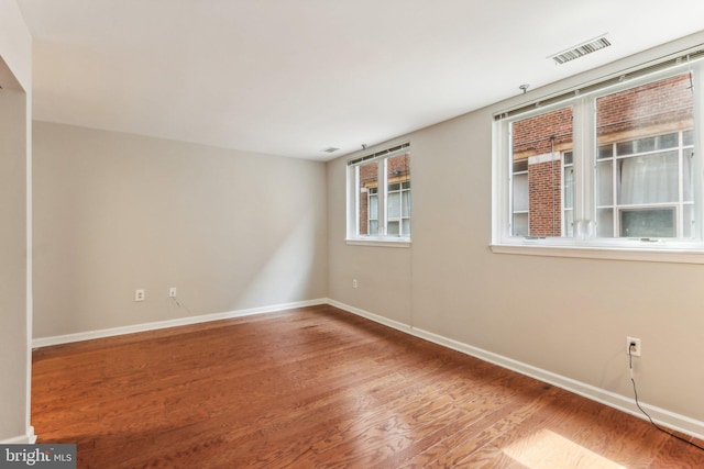 unfurnished room with hardwood / wood-style flooring