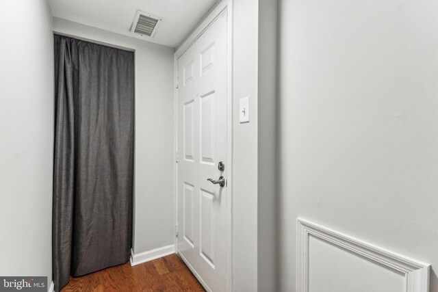 kitchen featuring appliances with stainless steel finishes, dark stone countertops, and light wood-type flooring