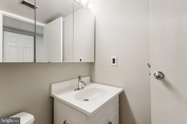 bathroom featuring toilet and vanity