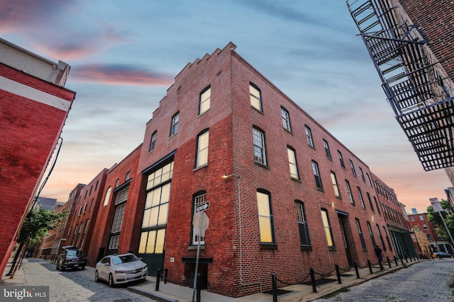 view of outdoor building at dusk