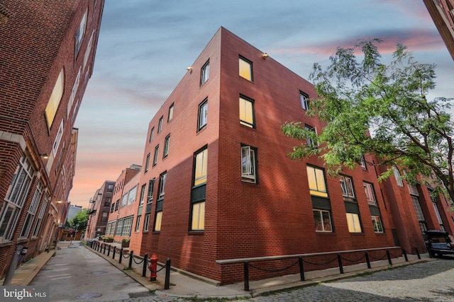 view of outdoor building at dusk