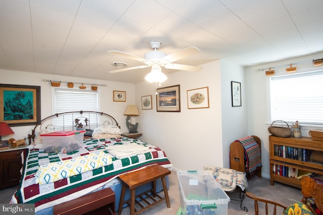 bedroom featuring ceiling fan and light colored carpet