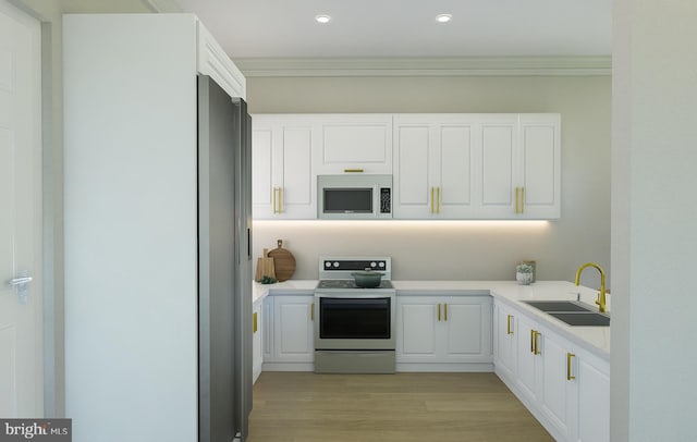 kitchen featuring sink, white cabinetry, crown molding, appliances with stainless steel finishes, and light hardwood / wood-style floors