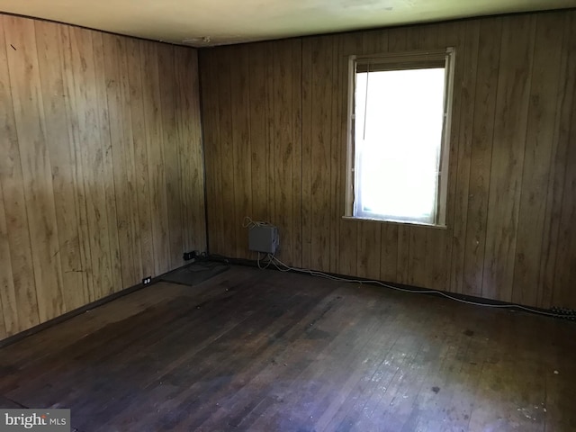 unfurnished room featuring dark wood-type flooring