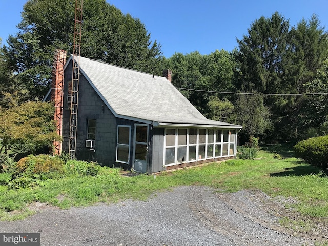 exterior space featuring a sunroom