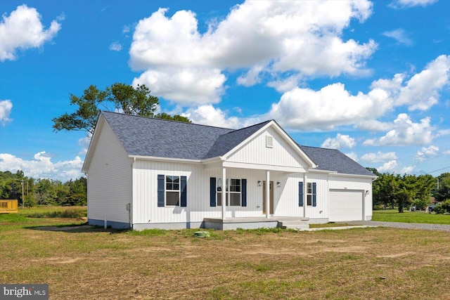 modern farmhouse with a garage, covered porch, and a front lawn