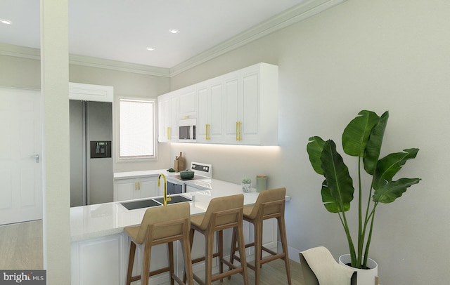 kitchen with sink, white appliances, white cabinetry, a kitchen breakfast bar, and kitchen peninsula