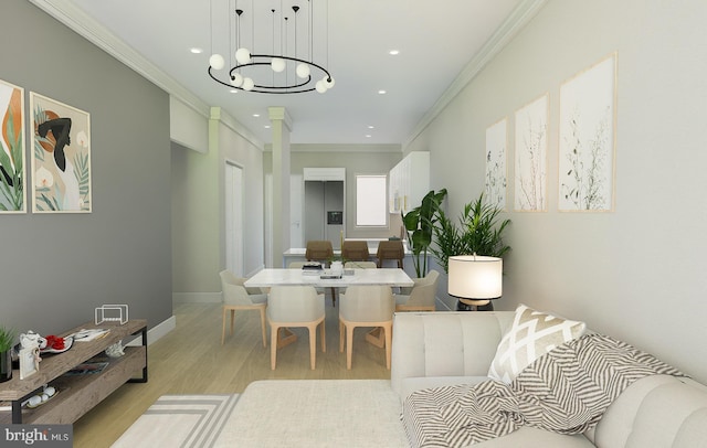 dining room featuring ornamental molding, a notable chandelier, and light wood-type flooring