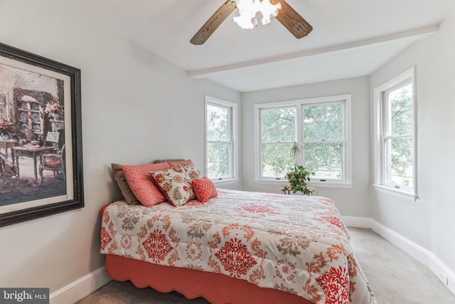 carpeted bedroom with ceiling fan and multiple windows