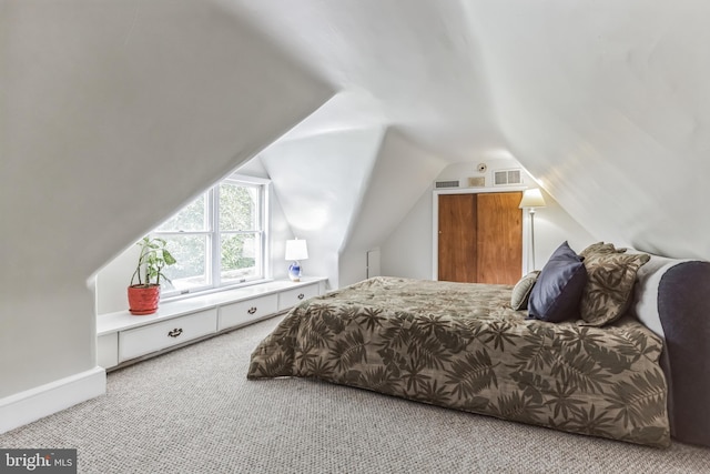 bedroom with carpet and lofted ceiling