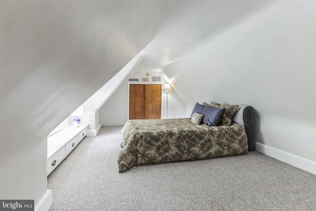 carpeted bedroom with vaulted ceiling