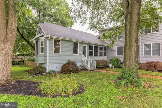 back of property featuring a lawn