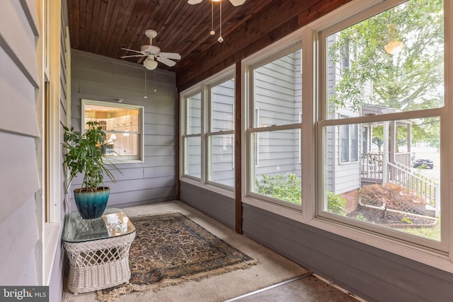 unfurnished sunroom featuring plenty of natural light and ceiling fan