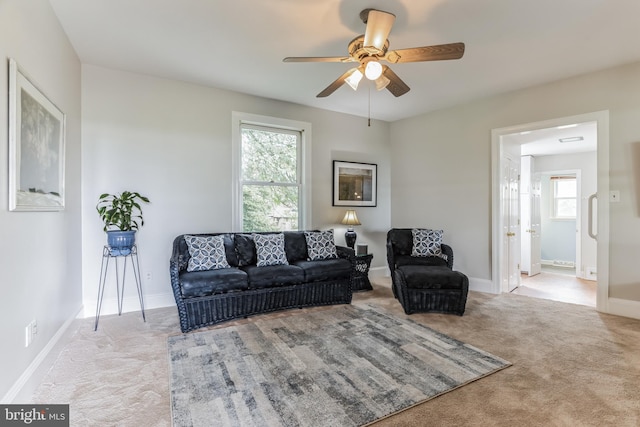 living room with ceiling fan and light carpet