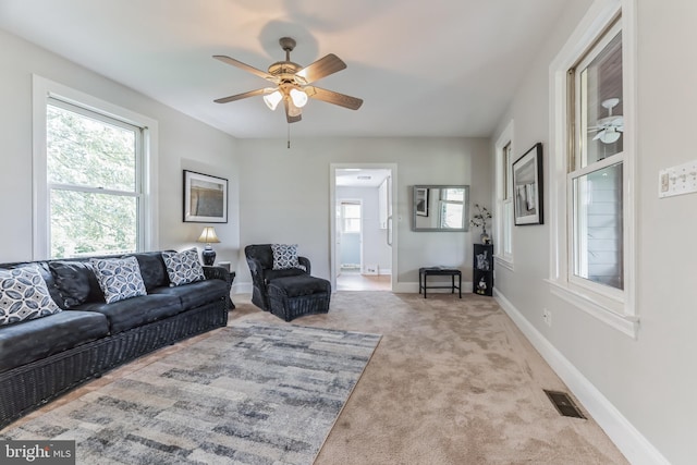 living room with light carpet and ceiling fan