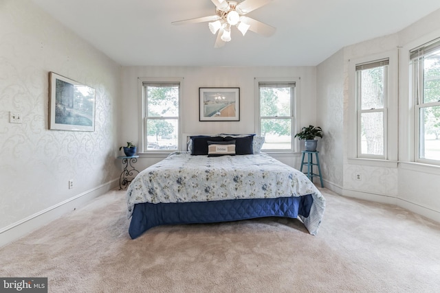 bedroom with ceiling fan and light colored carpet