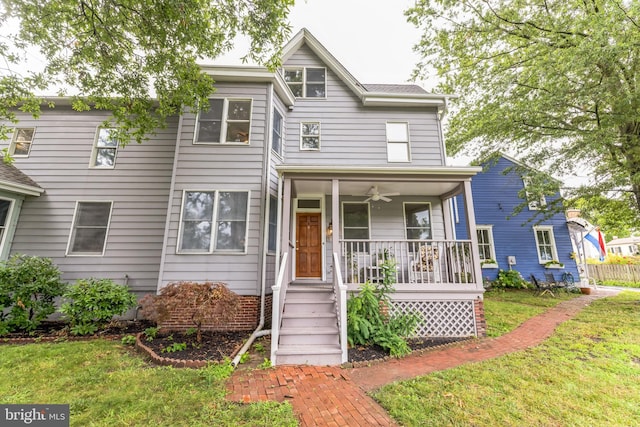 view of front of house featuring covered porch and a front yard