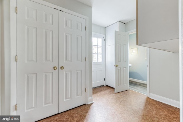 unfurnished bedroom with light wood-type flooring and a closet