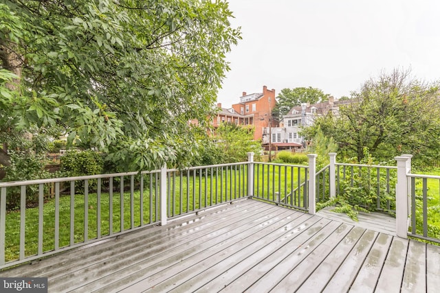 wooden deck featuring a yard