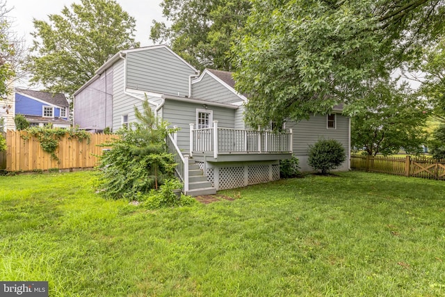 back of house with a lawn and a deck