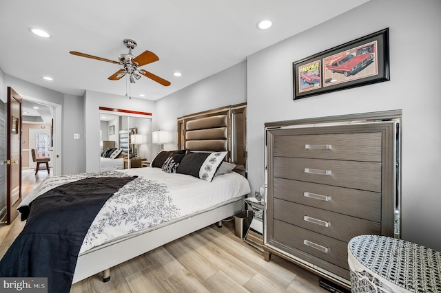 bedroom featuring ceiling fan, light hardwood / wood-style floors, and a closet