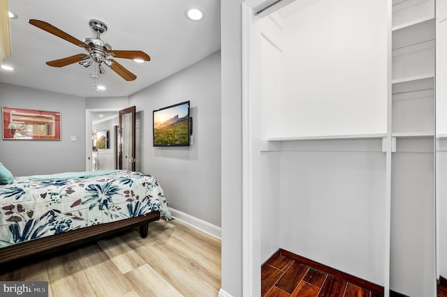 bedroom with ceiling fan and hardwood / wood-style floors