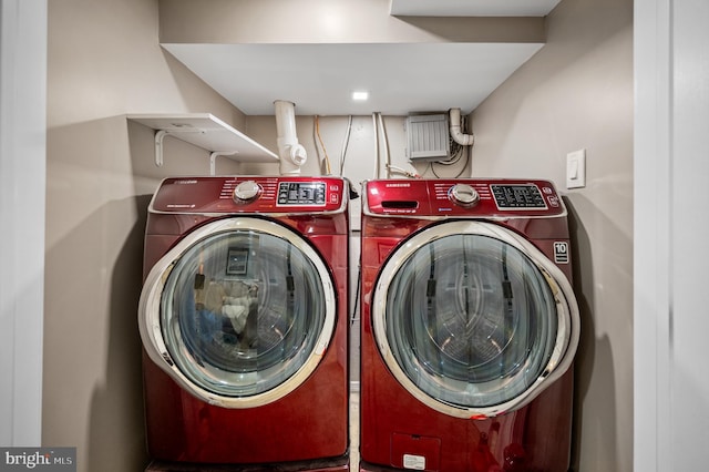 clothes washing area with washing machine and dryer