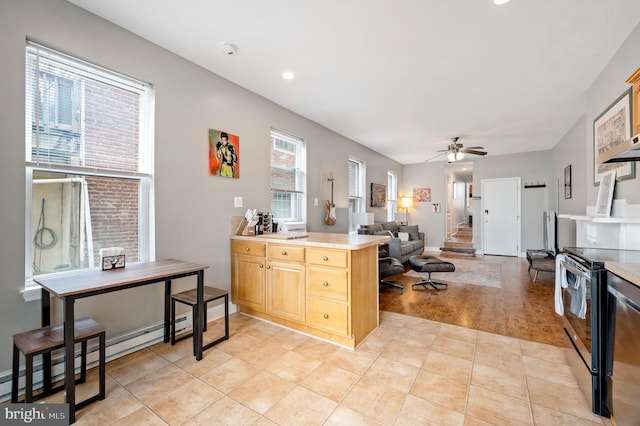 kitchen featuring stainless steel electric stove, a baseboard radiator, light hardwood / wood-style floors, ceiling fan, and kitchen peninsula