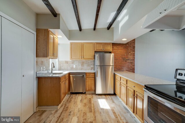 kitchen featuring sink, beam ceiling, light stone counters, light hardwood / wood-style floors, and stainless steel appliances