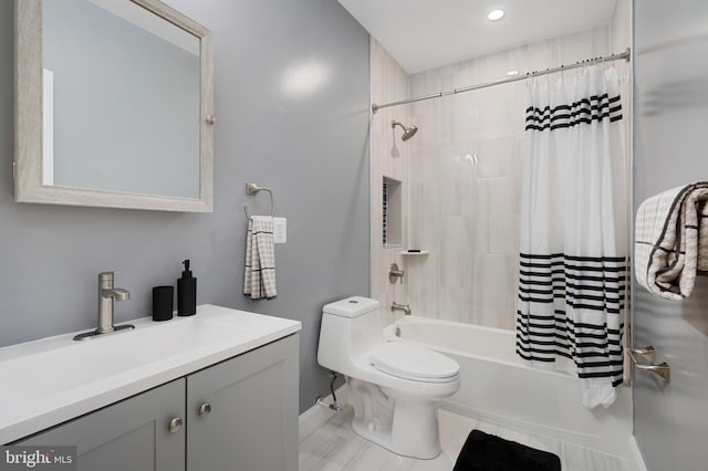 full bathroom with tile patterned flooring, shower / bath combination with curtain, vanity, and toilet