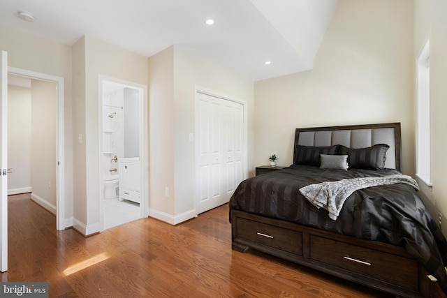 bedroom featuring recessed lighting, a closet, ensuite bathroom, wood finished floors, and baseboards