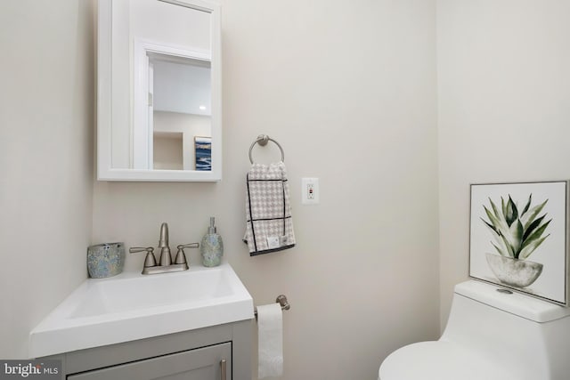 bathroom featuring toilet and vanity