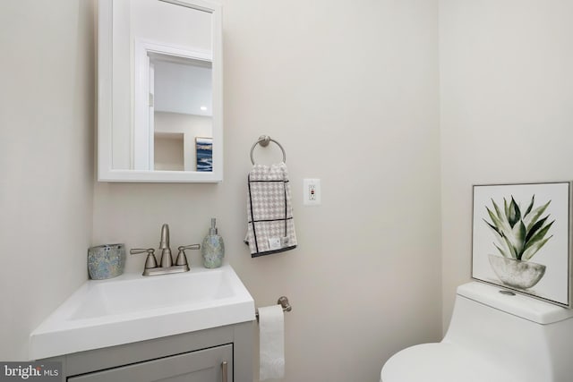 half bath with vanity and toilet