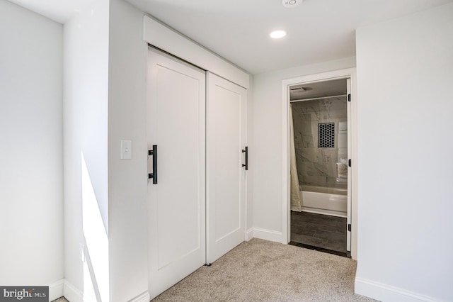 corridor with light colored carpet