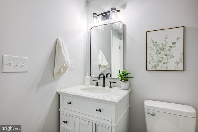 bathroom featuring toilet and vanity