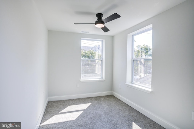 carpeted empty room featuring ceiling fan