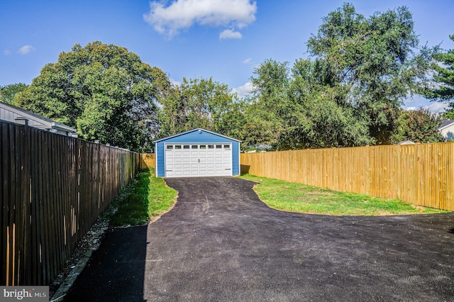 detached garage featuring fence