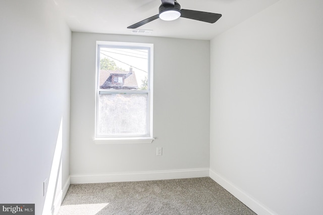 carpeted spare room featuring ceiling fan