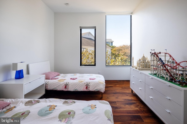 bedroom featuring dark wood-style flooring and multiple windows