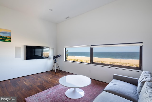 living area with visible vents and wood finished floors