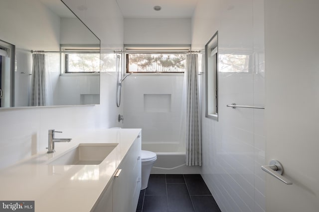 full bath with toilet, shower / bath combo with shower curtain, vanity, and tile patterned floors