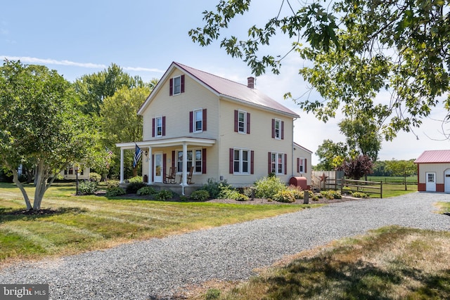 view of front of home with a porch and a front yard