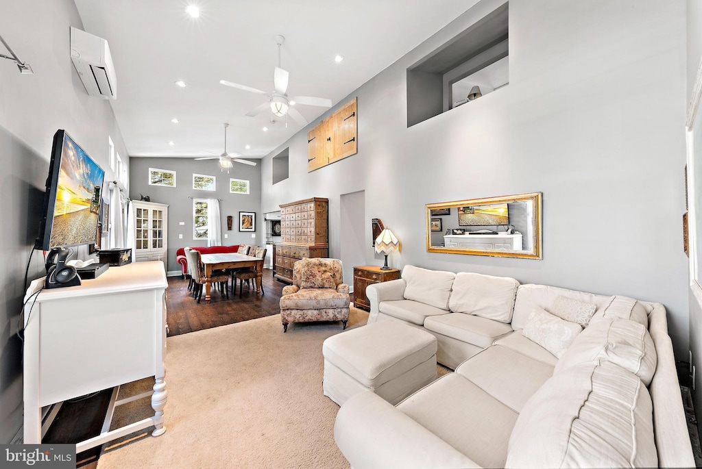 living room with carpet, high vaulted ceiling, ceiling fan, and a wall unit AC