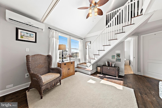 sitting room with dark hardwood / wood-style flooring, lofted ceiling, a wall mounted air conditioner, and ceiling fan