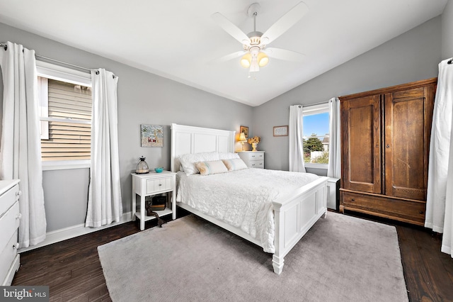 bedroom featuring ceiling fan, dark hardwood / wood-style floors, and lofted ceiling