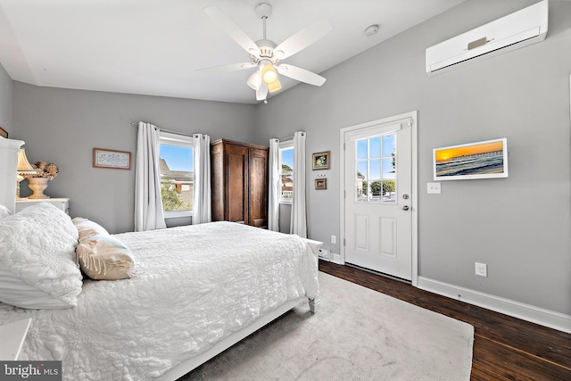 bedroom featuring ceiling fan, a wall mounted AC, dark hardwood / wood-style floors, and lofted ceiling