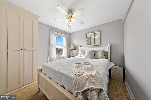 bedroom featuring ceiling fan, a closet, and light hardwood / wood-style flooring