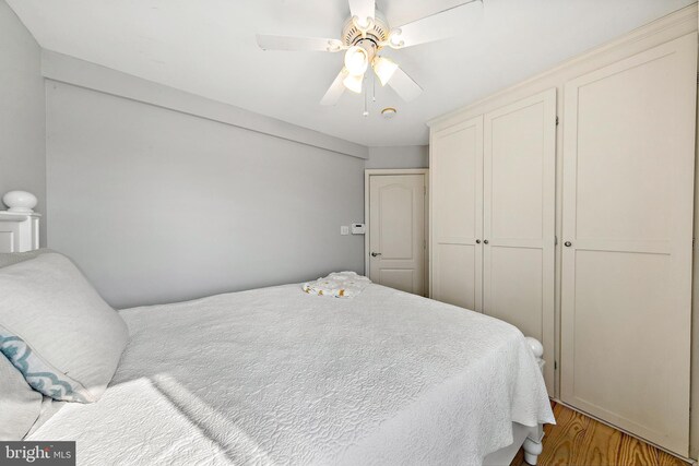 bedroom with ceiling fan and light hardwood / wood-style floors